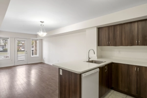 Kitchen overlooking living room of unit 238 located at 2355 Sheppard Avenue West in Etobicoke, Ontario listed by Marco Pedri, Broker with Shoreline Realty Corp., Brokerage.