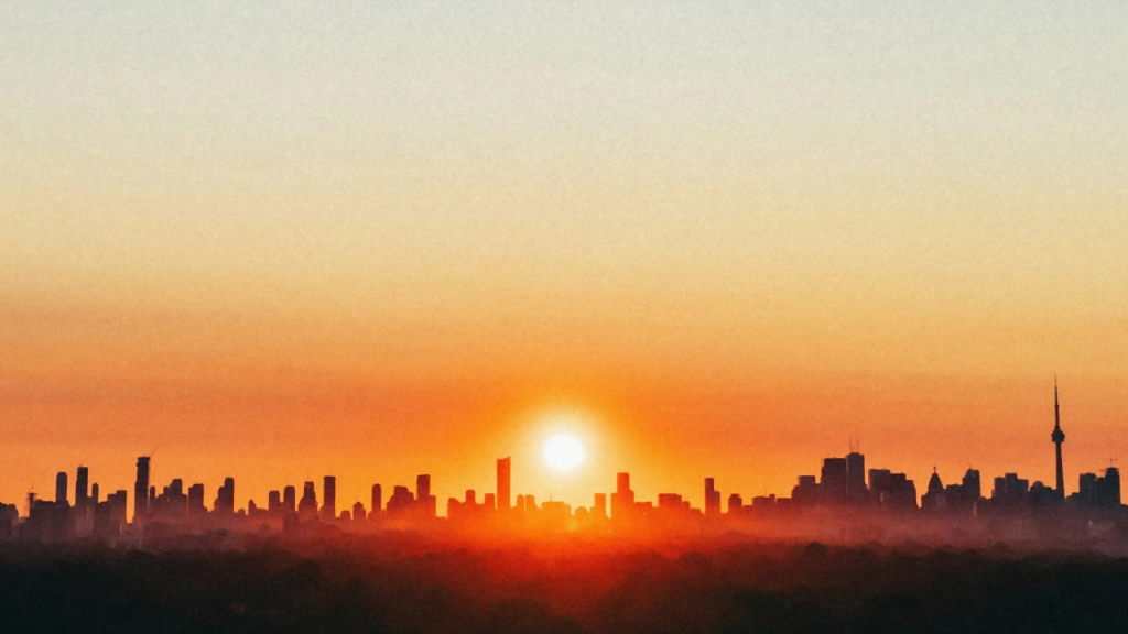 An image of the Toronto skyline with the sun setting.